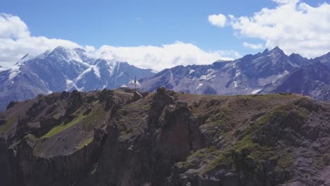 mountain peak with windmill and snow