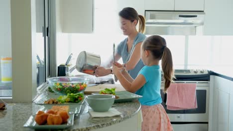 Mother-and-daughter-preparing-food-in-kitchen-4k