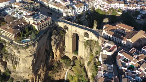 ronda spain in the province of málaga with puente nuevo arch bridge joining the villages, aerial tilt down reveal shot