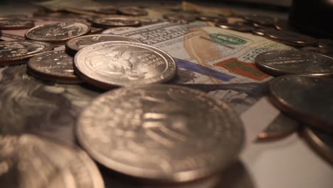 coins and dollars fall on table closeup