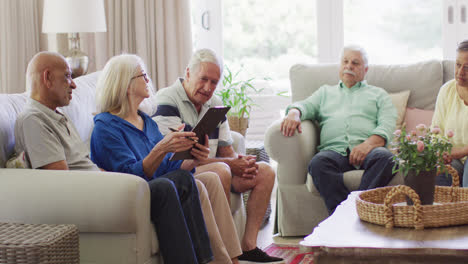 Senior-caucasian-female-therapist-making-notes,-talking-with-diverse-senior-friends,-slow-motion