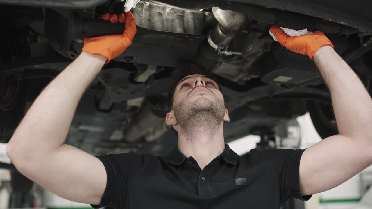 Mechanic working under car