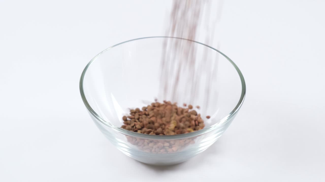Green lentils in a glass bowl on white background. Healthy organic food diet concept. Fresh natural food ingredient