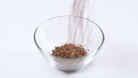green lentils in a glass bowl on white background. healthy organic food diet concept. fresh natural food ingredient