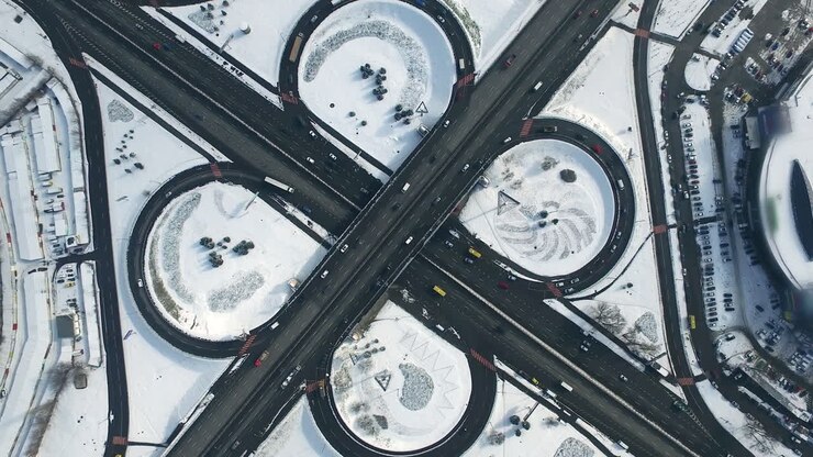 Top view freeway intersection. Aerial view cars traffic on winter highway