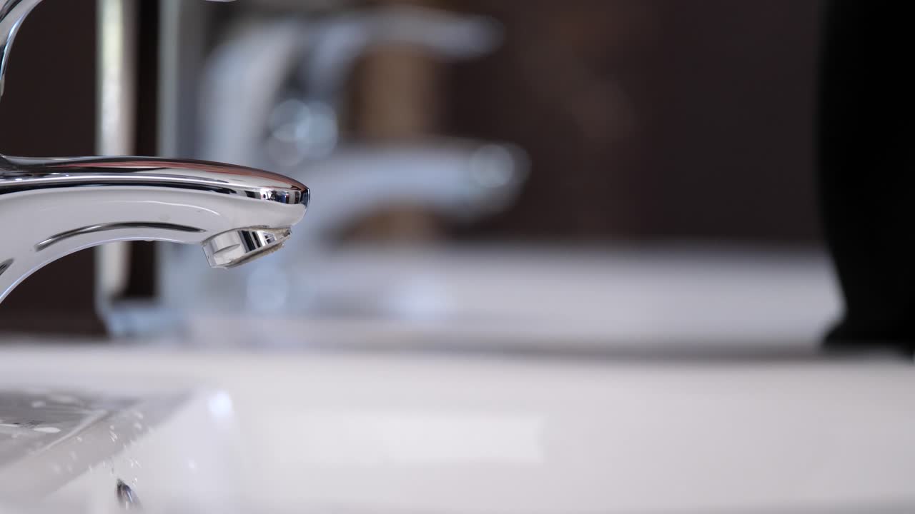 Washing female hands throughly with liquid soap, close up