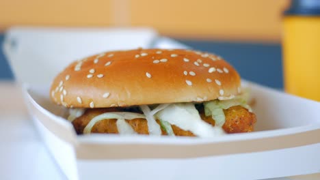 close up of a chicken burger in a box