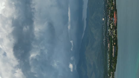 Dramatic-cloudscape-over-the-Ouemo-peninsula-of-Noumea,-New-Caledonia---vertical-time-lapse