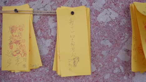 lots of prayers written on colourful papers hanging on temple wall