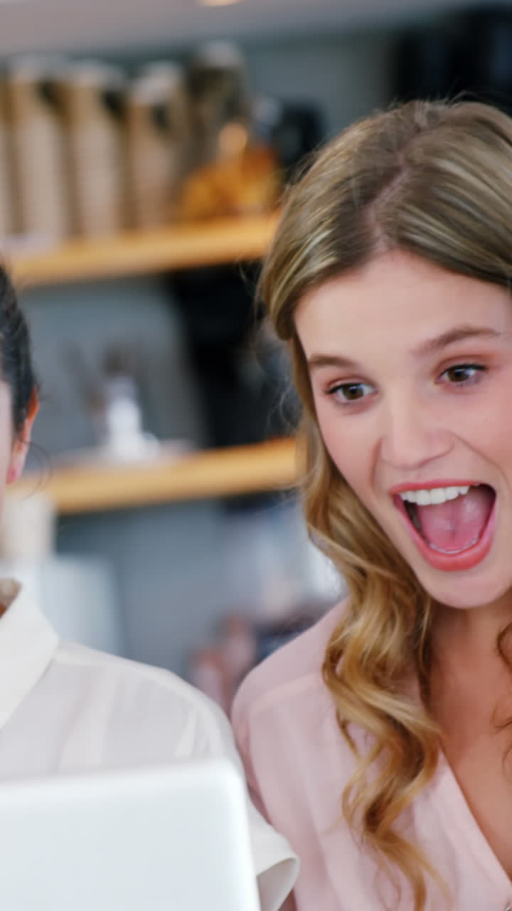 Excited friends using laptop