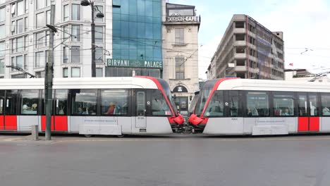 istanbul tram at intersection with buildings and vehicles