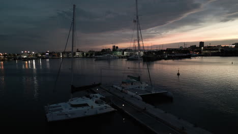 drone revealing boats docked in the yacht club during sunset
