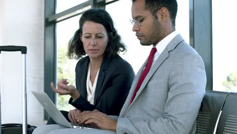 colegas de negocios serios usando computadoras portátiles