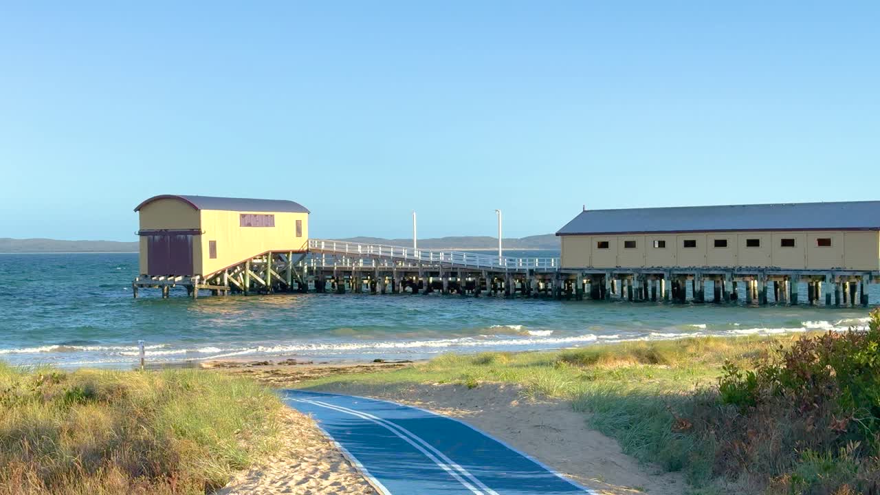 A tranquil view of Queenscliff pier with gentle waves and soft evening light, captured in a 16-second video