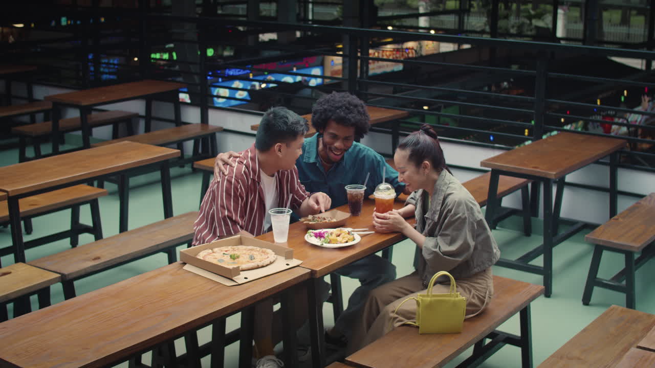 Multicultural Friends Eating Pizza and Snacks in Food-court