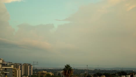 Amazing-time-lapse-of-a-sunset-above-the-city,-was-shot-from-the-roof,-Israel-Tel-Aviv,-middle-east,-colorful-surfing-clouds,-golden-hour,-cityscape,-Sony-4K-video