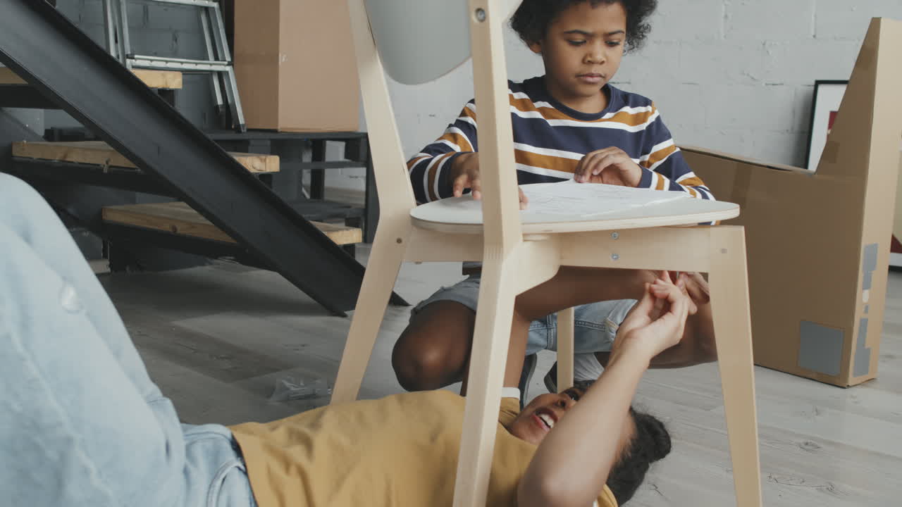 Mother and Child Assembling Furniture Together