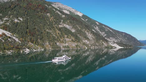 cruise boat tour at mountain lake achensee in tyrol, austria - aerial 4k