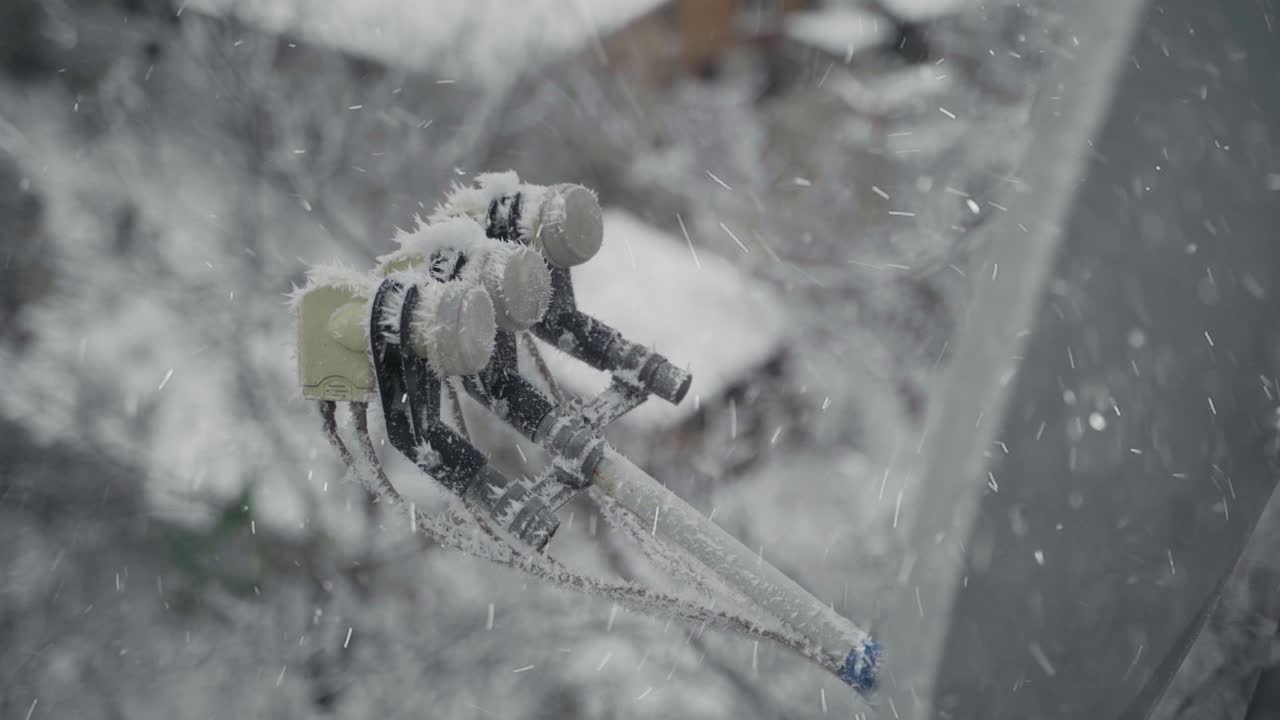 Satellite dish in snow. Satellite dish frozen hanging on front cottage wall in a snowy winter outdoors