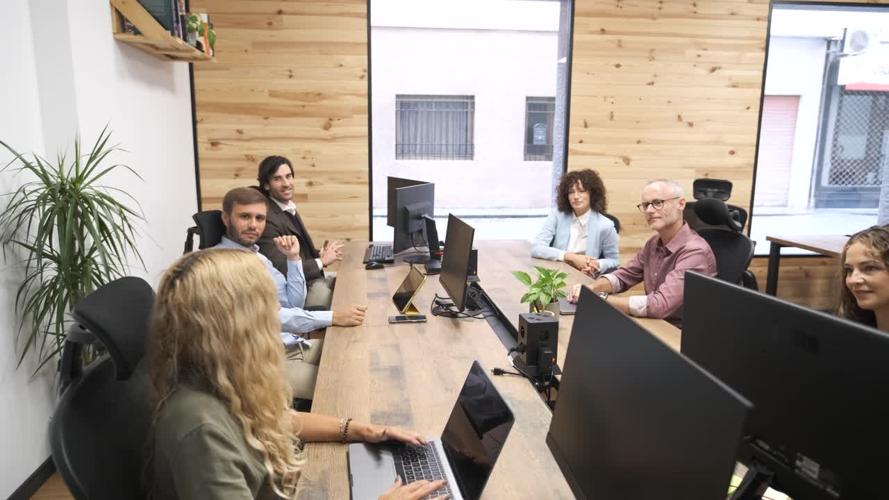 Group of colleagues working together on project in office
