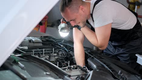 mechanic inspecting a car engine in a garage