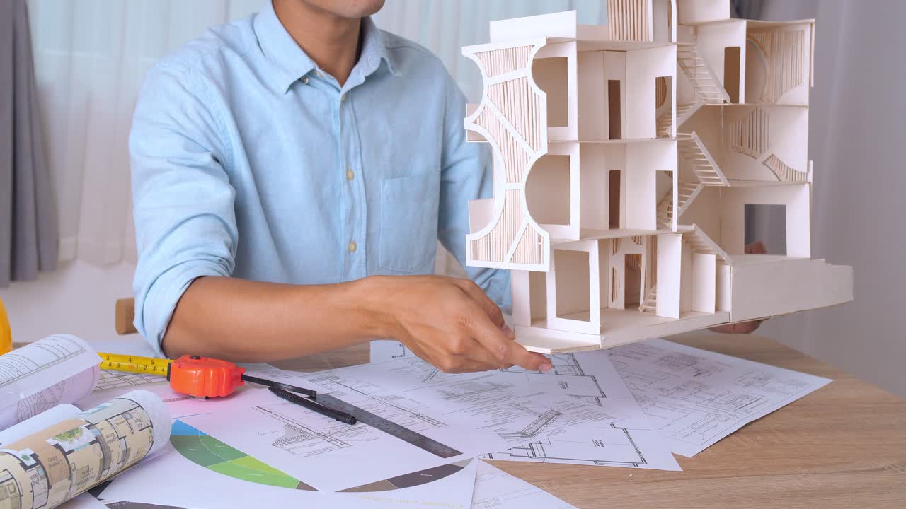 Young Architect With House Model