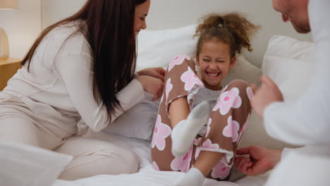 bedroom, tickle and child with parents playing