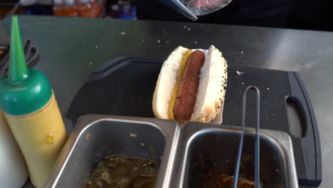 a food service worker prepared a hot dog sandwich in a fast food diner