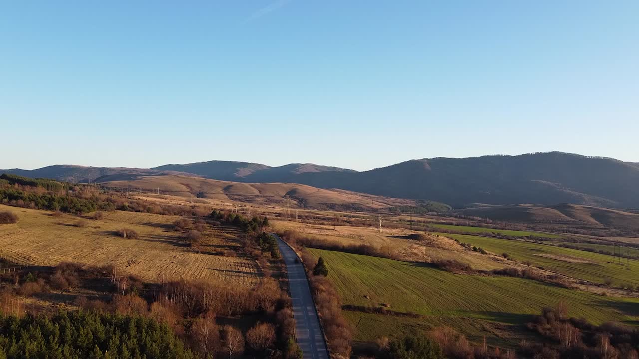 Drone footage of a vehicle traveling on a road in the Balkan mountains, Bulgaria
