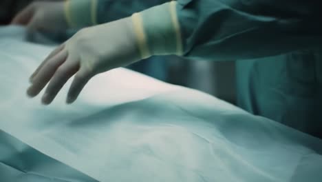 medical professionals perform a surgical procedure in a modern operating room. the atmosphere is focused and sterile, showcasing the intricate preparation and teamwork involved in healthcare.