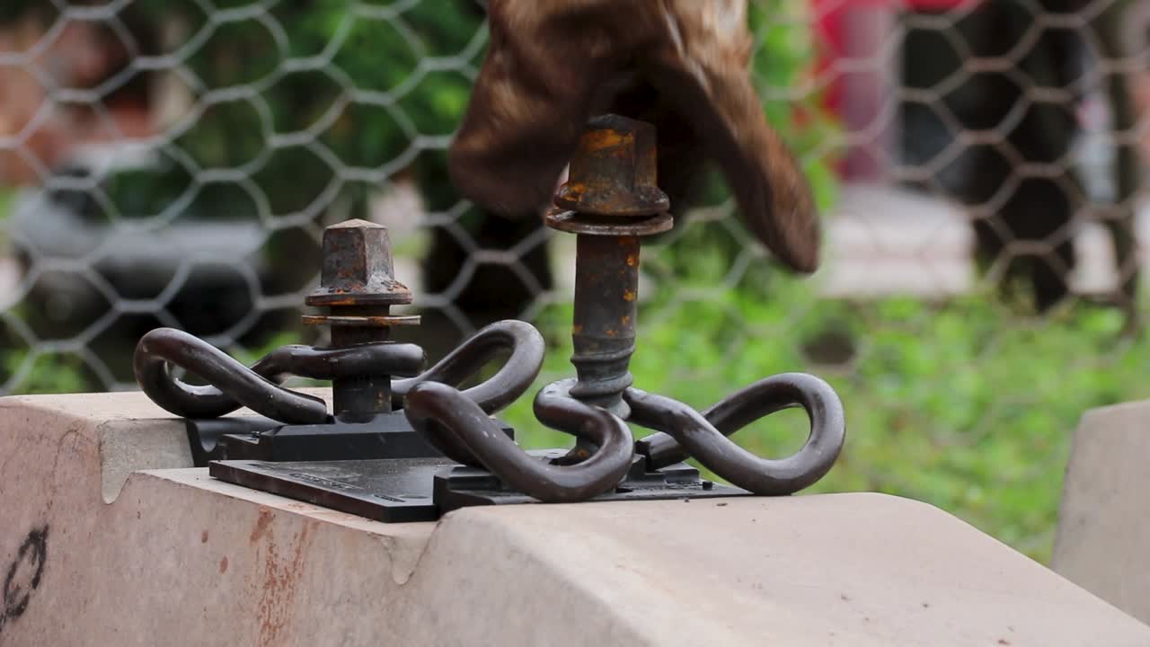 Worker adjusts railway track in Buenos Aires industrial urban setting