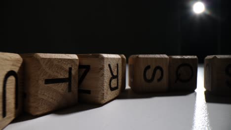 wooden letter blocks lined up with backlight