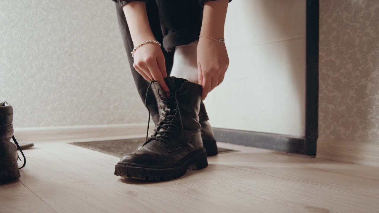 Prepared for adventure. Ready to step into outdoors. Stepping boldly into wilderness with purposeful determination. Dawn breaks as sturdy boots are laced tightly for exploration ahead