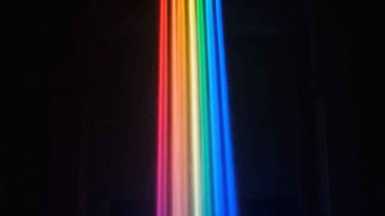A Stunning Display of Color: A Mesmerizing Rainbow Cascade Illuminating the Dark Space, Creating a Vibrant Atmosphere of Light and Beauty