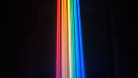 A Stunning Display of Color: A Mesmerizing Rainbow Cascade Illuminating the Dark Space, Creating a Vibrant Atmosphere of Light and Beauty