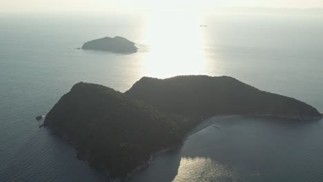 Aerial-drone-landscape-in-japanese-sunrise-island-islet-with-sun-shining-reflecting-water-pacific-ocean-vibes-at-Japan-summer-in-Wakayama-coastline