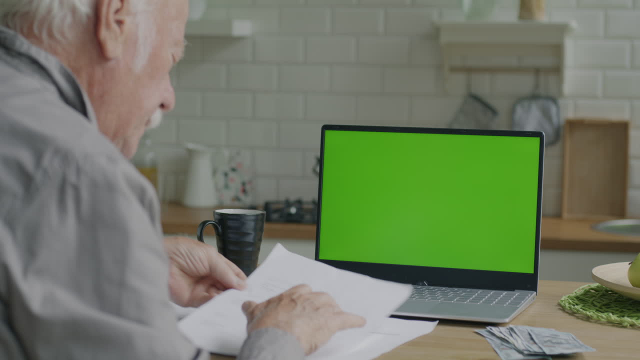 Senior Man Reviewing Documents at Home