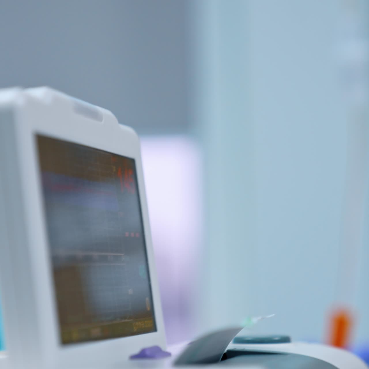 Female nurse looks at the drop counter with dripping medicines. Medical equipment working in the hospital ward