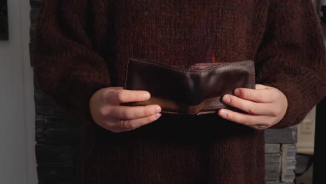 Woman-holding-empty-wallet,-flames-coming-from-billfold