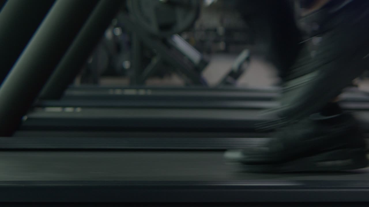 an athlete running full speed on a Treadmill , Static medium shot