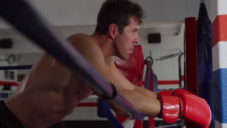 caucasian man resting in boxing ring