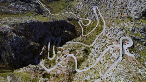 aerial drone view of coll dels reis mountain pass with the serpentine road of nus de sa corbata in mallorca, spain