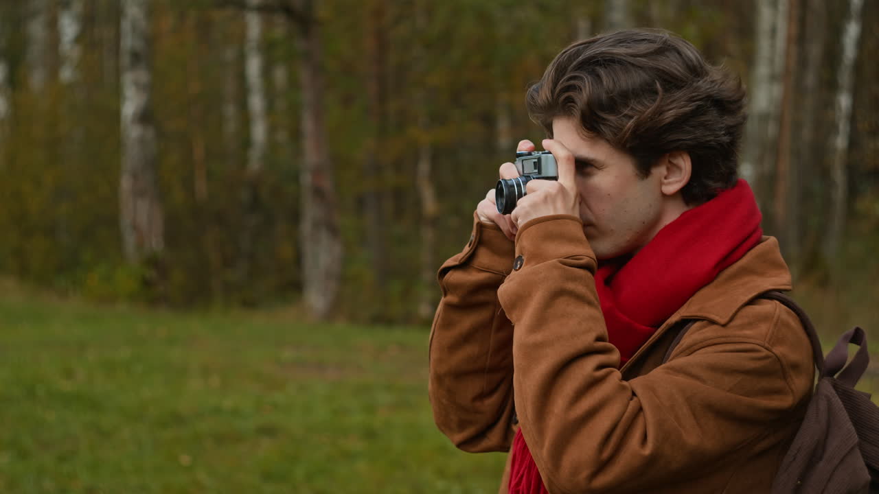 Man taking pictures in autumn