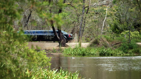 black stretch limousine arriving at outdoor country wedding, slow motion