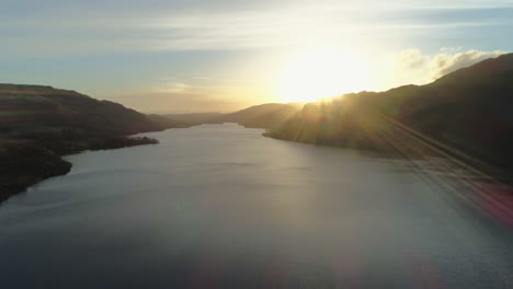 high aerial drone shot of ullswater lake at stunning beautiful sunrise lake district cumbria united kingdom