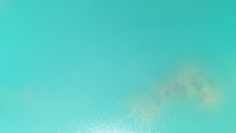 lifting aerial shot of an incredibly blue lake