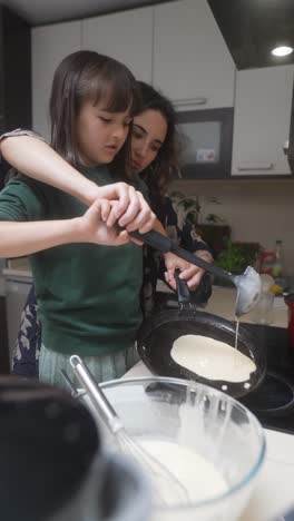 mother and daughter making pancakes