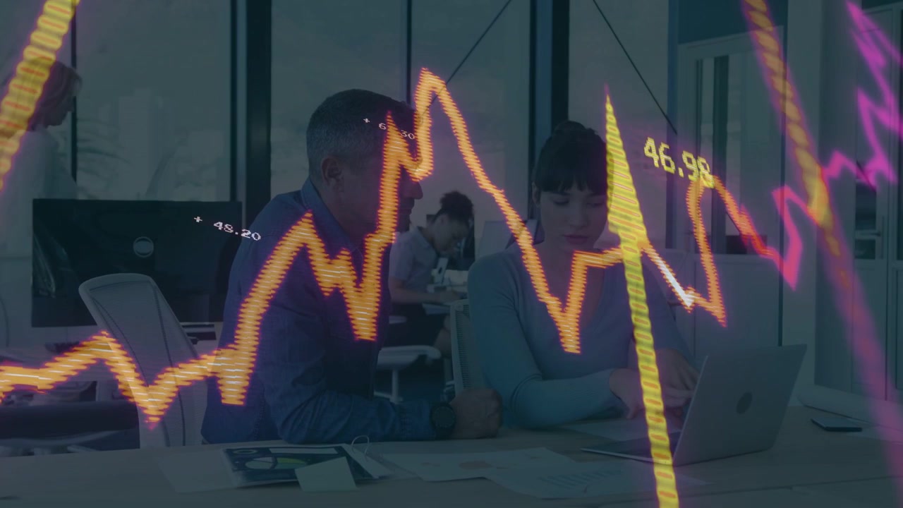Woman typing and pointing man leaning causing chart sweeping across obscuring analyzing market data