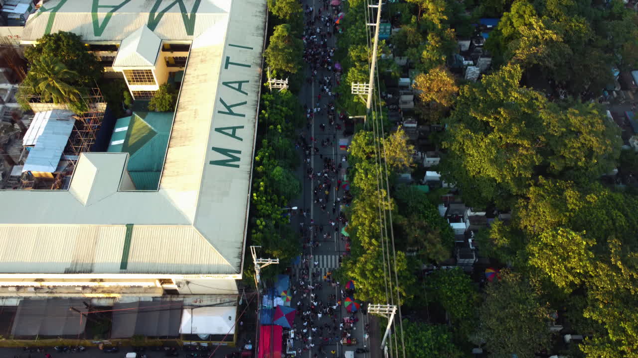 High angle aerial of crowded streets of Makati, Undas festival in Philippines
