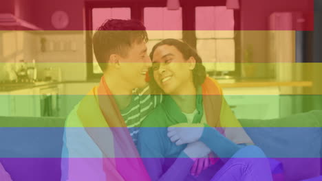 embracing on couch, couple with rainbow flag animation in background